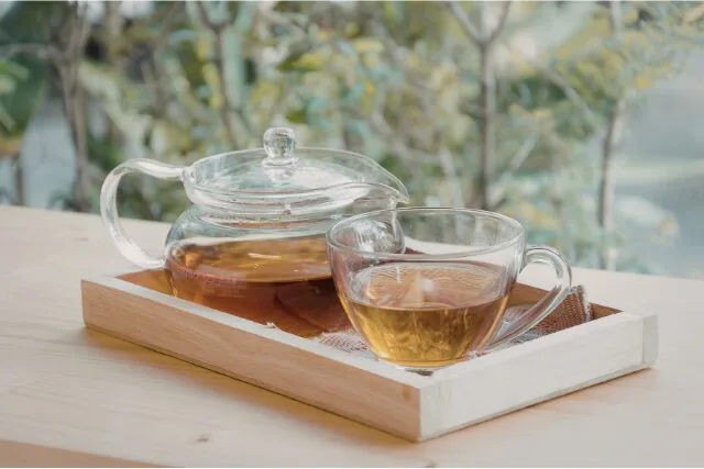 ハーブティーが入ったガラスポットとカップの写真